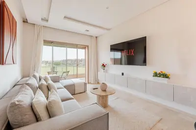 a living room with a couch and a tv at Luxury Appartement Golf and Pool in Marrakech