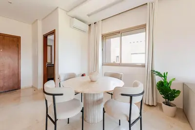a dining room with a table and chairs at Luxury Appartement Golf and Pool in Marrakech
