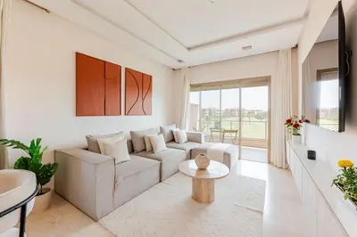 a living room with a couch and a table at Luxury Appartement Golf and Pool in Marrakech