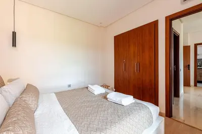 a bedroom with a bed and a wooden cabinet at Luxury Appartement Golf and Pool in Marrakech