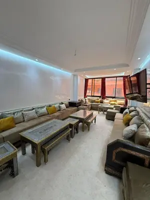 a large living room with a large couch and tables at BIG comfort with pool North Gueliz RIAD Ambiance in Marrakech