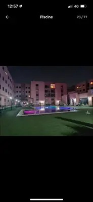 a picture of a building at night with lights at BIG comfort with pool North Gueliz RIAD Ambiance in Marrakech