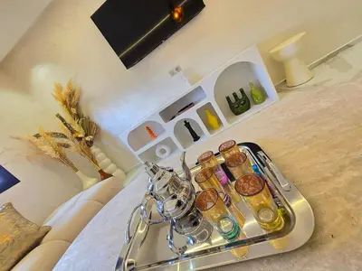 a tray of food sitting on top of a bed at Appartement avec piscine in Marrakech