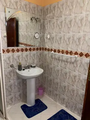 a bathroom with a sink and a mirror at 2 bedroom apartment with Moroccan living room in Allal El Fassi in Marrakech
