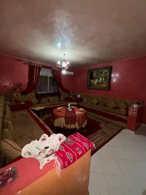 a living room with a couch and a table at 2 bedroom apartment with Moroccan living room in Allal El Fassi in Marrakech