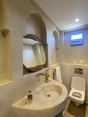 a bathroom with a sink and a toilet at Riad Bab Yacout & SPA in Marrakech