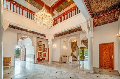 a large living room with a chandelier at Taj Palmeraie Palace Marrakech in Marrakech