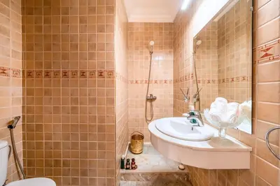 a bathroom with a sink and a shower and a toilet at Taj Palmeraie Palace Marrakech in Marrakech