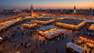 a group of people walking around a market at night at Pause rêvée au cœur de Marrakech in Marrakech
