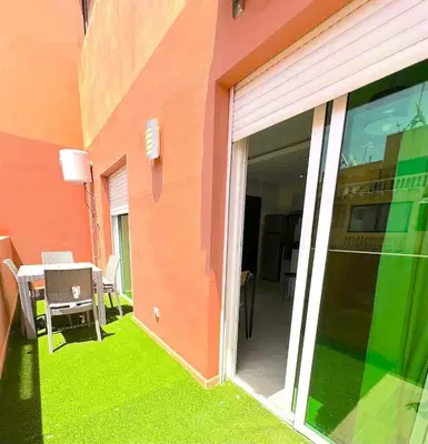 a building with a sliding glass door with a table at Pause rêvée au cœur de Marrakech in Marrakech