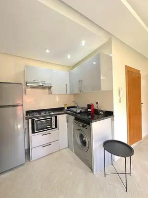 a kitchen with a stove and a dishwasher at Pause rêvée au cœur de Marrakech in Marrakech
