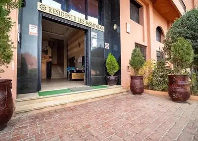 a entrance to a building with potted plants outside at Appartement Centre Ville Gueliz Parking Inclus in Marrakech