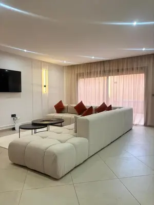 a living room with a white couch and a table at Elegant Duplex 2 chambres in Marrakech