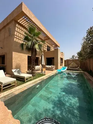 a swimming pool in front of a house at Villa familiale a 10km du boulevard Mohamed VI in Marrakech