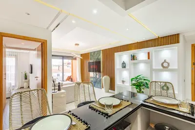 a kitchen and dining room with a table and chairs at Sakina Appartement Luxe Gueliz in Marrakech