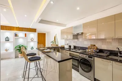 a large kitchen with a washer and dryer at Sakina Appartement Luxe Gueliz in Marrakech