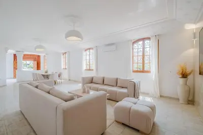 a large living room with couches and a table at Very comfortable villa in the heart of Marrakech in Marrakech