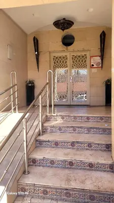 a set of stairs in a building with a door at L'AUTHENTIQUE 37 face de la gare CTM Hivernage in Marrakech