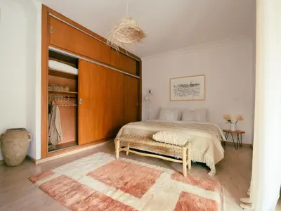 a bedroom with a bed with a wooden headboard at Cozy apartment Marrakech hivernage with nice terrace in Marrakech