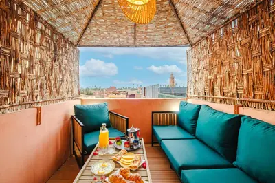 a room with a couch and a table with food at Riad - Jacuzzi & Breakfast , 5min walk Jemaa El Fnaa & Vue Rooftop Médina in Marrakech