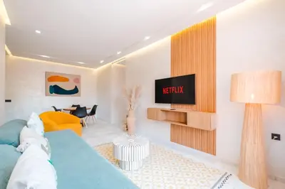 a living room with a tv on a wall at Modern and Cozy Apartment Center of Marrakech in Marrakech