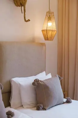 a bedroom with a bed with pillows and a lamp at Modern and Cozy Apartment Center of Marrakech in Marrakech