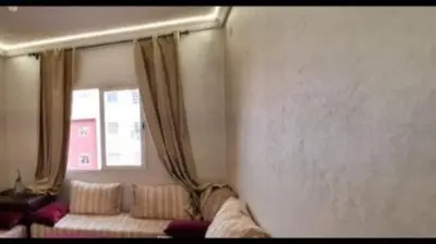 a living room with a couch and a window at Appartement familiale au centre de Marrakech à 7min de gueliz in Marrakech