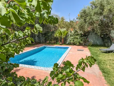 a swimming pool in the backyard of a house at Villa Atlas Chill in Marrakech