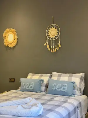 a bedroom with a bed with blue pillows and a chandelier at Villa Atlas Chill in Marrakech