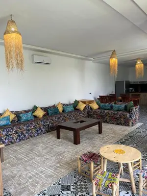 a living room with a couch and a table at Villa familiale, piscine privée sans vis-à-vis in Marrakech
