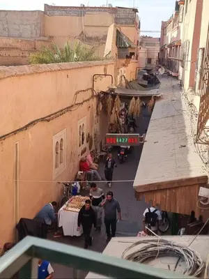 a group of people walking down a street at amazing home and amazing rooftop in Marrakech