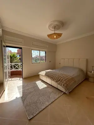 a bedroom with a large bed and a rug at Villa moderne avec jacuzzi & jardin - Marrakech in Marrakech