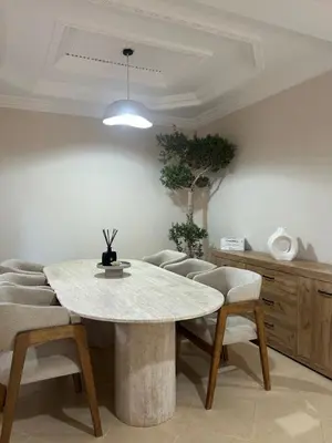a dining room with a white table and chairs at Villa moderne avec jacuzzi & jardin - Marrakech in Marrakech