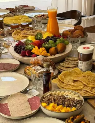a table with many plates of food on it at Villa moderne avec jacuzzi & jardin - Marrakech in Marrakech
