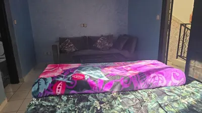 a bedroom with a bed and a couch at Riad Zaitone 146 in Marrakech