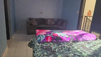 a bedroom with a bed and a couch in a room at Riad Zaitone 146 in Marrakech