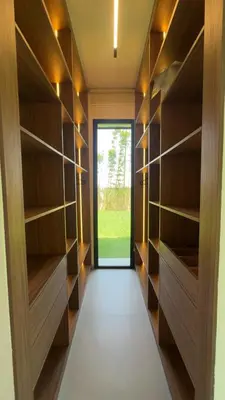 a walk in closet with wooden shelves and a door at Villa Selma in Marrakech