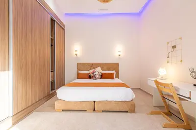 a bedroom with a large bed and a desk at Villa Safiya, Piscine Chauffée & jeux in Marrakech
