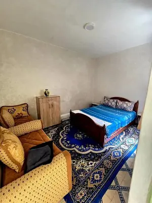 a bedroom with a large bed and a couch at light stay in Marrakech