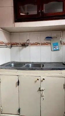 a kitchen counter with a sink and a mirror at light stay in Marrakech