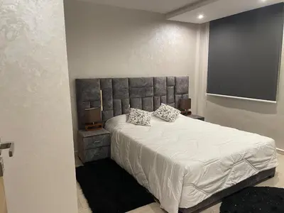 a bedroom with a large bed with two pillows on it at Apartment for rent ,Duplex in Marrakech