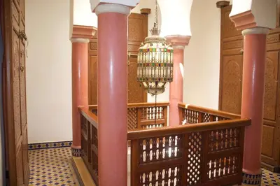 a hallway with pink columns and a chandelier at Riad-style villa with a private pool in Marrakech