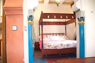 a bedroom with a canopy bed in a room at Riad-style villa with a private pool in Marrakech