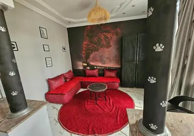 a living room with a red couch and a red rug at cozy villa in Marrakech