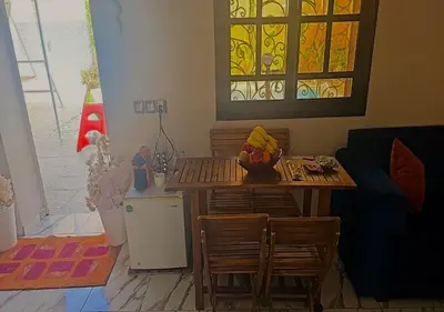 a living room with a table and chairs and a stained glass window at cozy villa in Marrakech