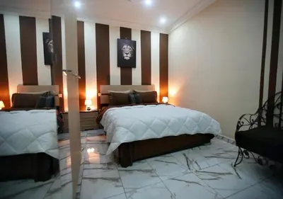 a bedroom with a bed and a striped wall at cozy villa in Marrakech