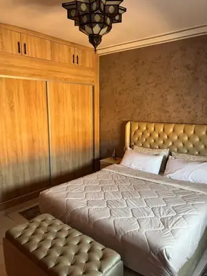 a bedroom with a large bed with a tufted headboard at Marrakech gulize in Marrakech