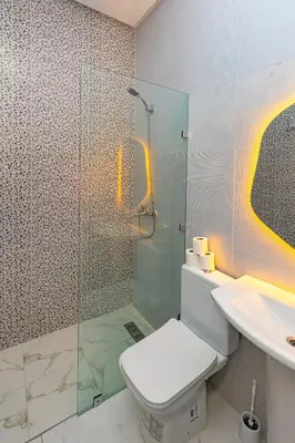 a bathroom with a shower and a toilet and a sink at Elegant and Modern Apartment, Calm Cosy and Central in Marrakech