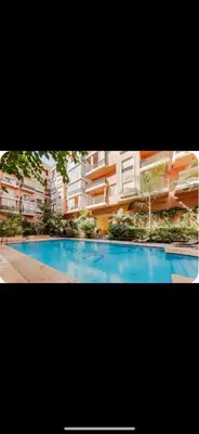 a picture of a swimming pool in front of a building at Un oasis au cœur de la ville, Rouge in Marrakech
