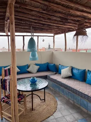 a living room with a couch and a table at Riad EL BADIS in Marrakech